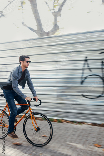 Young man riding his citybike photo