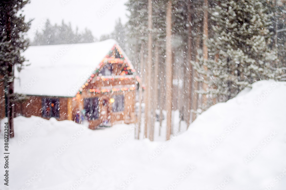 Ski cabin in a forest surrounded by snow and falling snowflakes Ski cabin in a forest surrounded by snow and falling snowflakes