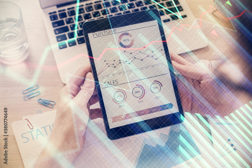 Double exposure of man's hands holding and using a digital device and forex graph drawing. Financial market concept. Double exposure of man's hands holding and using a digital device and forex graph drawing. Financial market concept.
