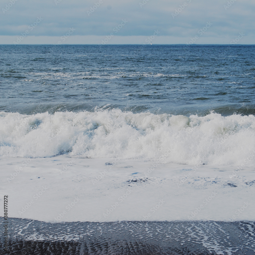 Waves crash on the shoreline of a beach Waves crash on the shoreline of a beach