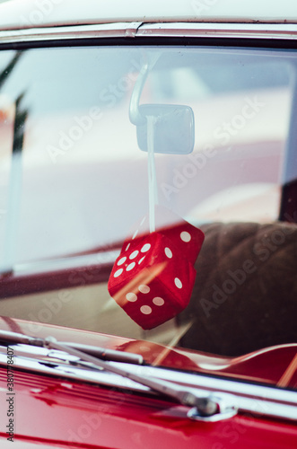 fuzzy red dice in a classic red car photo