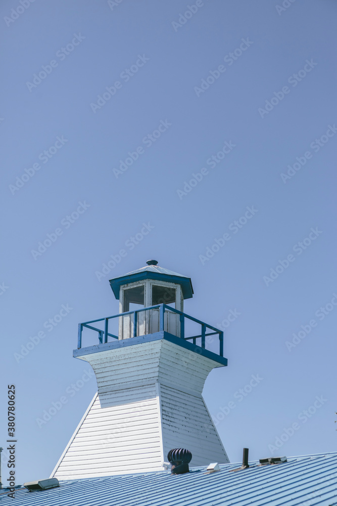 Small Lakeshore Town Lighthouse on a Building Roof Small Lakeshore Town Lighthouse on a Building Roof