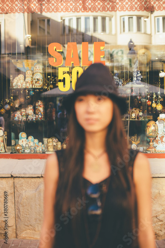Out of focus portrait in front of shopwindow