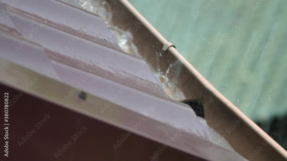 Heavy Rain Hitting House Roof and Rain Gutter During Thunderstorm