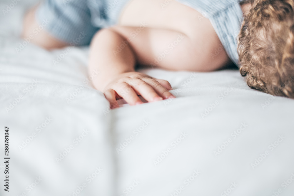 Baby relaxing on a white bed Baby relaxing on a white bed