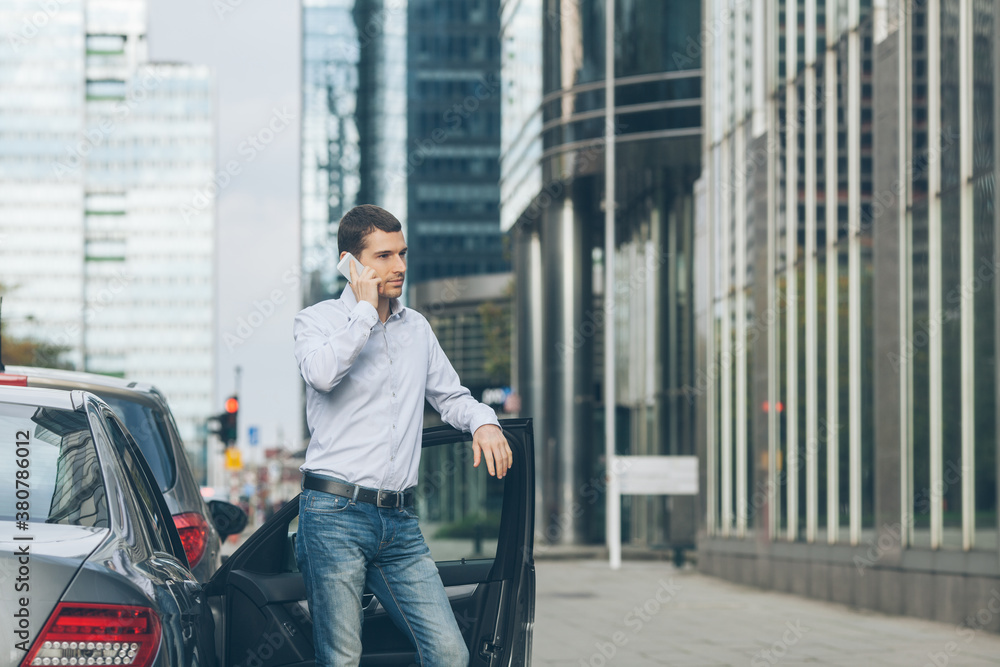 Businessman Standing by the Car and Talking on the Phone Businessman Standing by the Car and Talking on the Phone