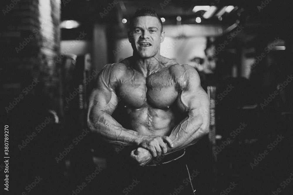 Male bodybuilder lifting weights in gym Male bodybuilder lifting weights in gym