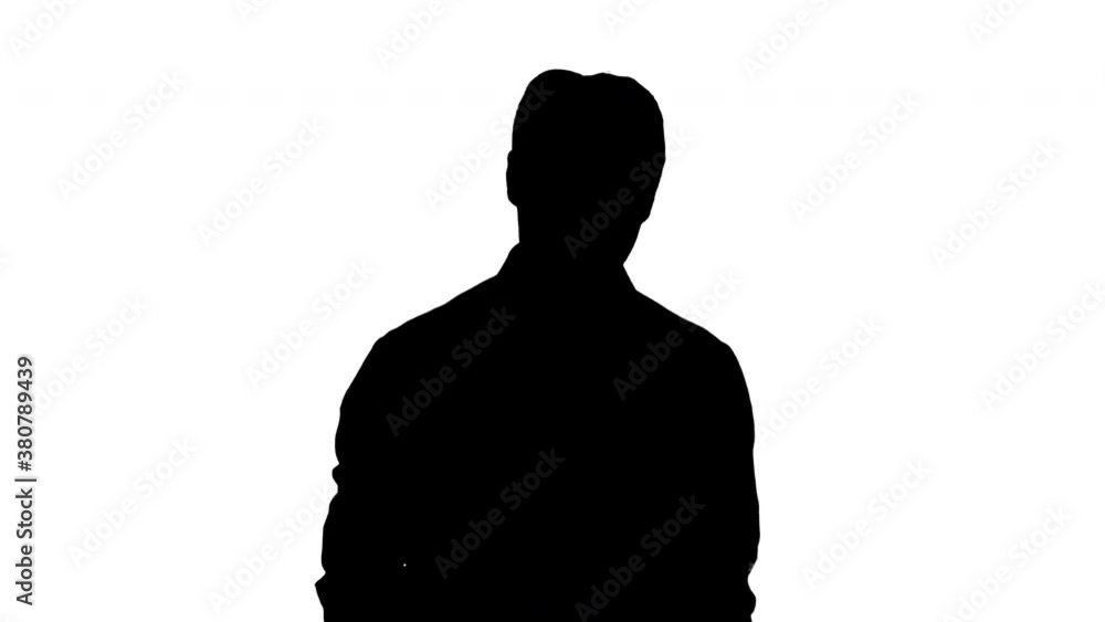 Silhouette Man in white shirt walking using cell phone.