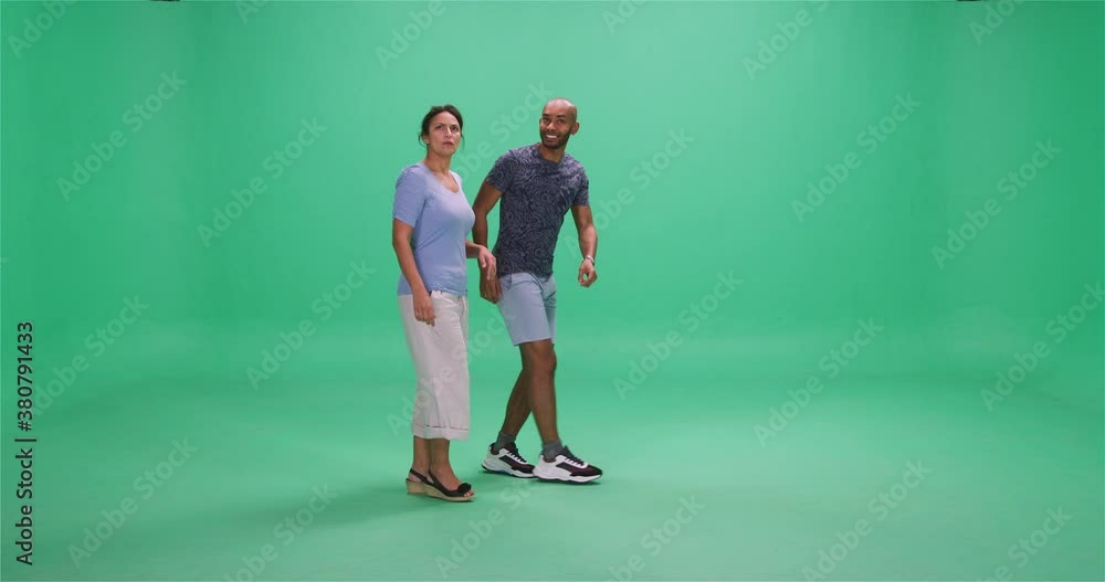 Man and woman pointing and looking into distance, greenscreen Man and woman pointing and looking into distance, greenscreen