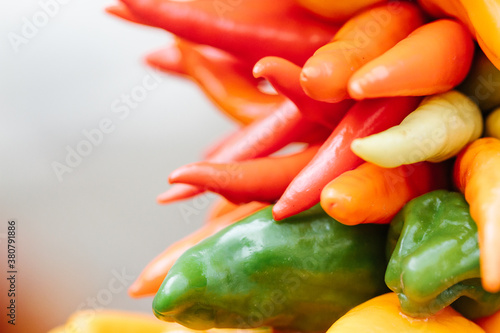 Multicolored chili pepper ristra wreath hanging for sale at local farmers market photo