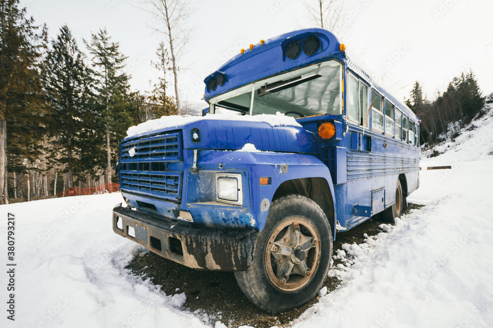 Blue school bus on snow Blue school bus on snow