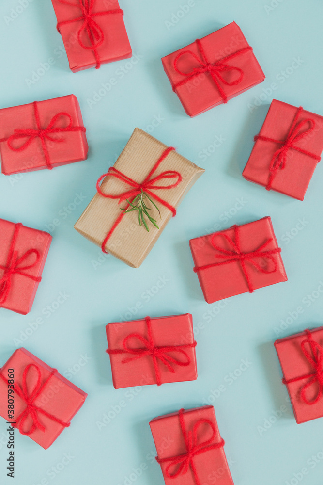 Big brown christmas gift surrounded by small red gifts on blue background Big brown christmas gift surrounded by small red gifts on blue background