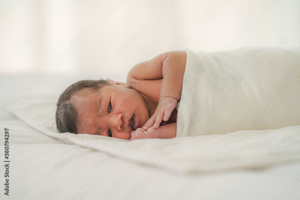 african american new born baby lying on white bed african american new born baby lying on white bed