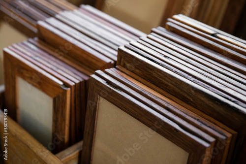 A collection of hand crafted wooden picture frames organised into groups by size and type of treatment.