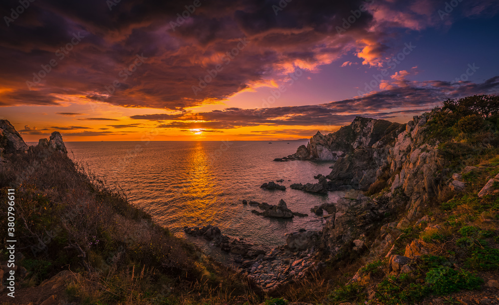 Sunset over the sea and sharp rocks