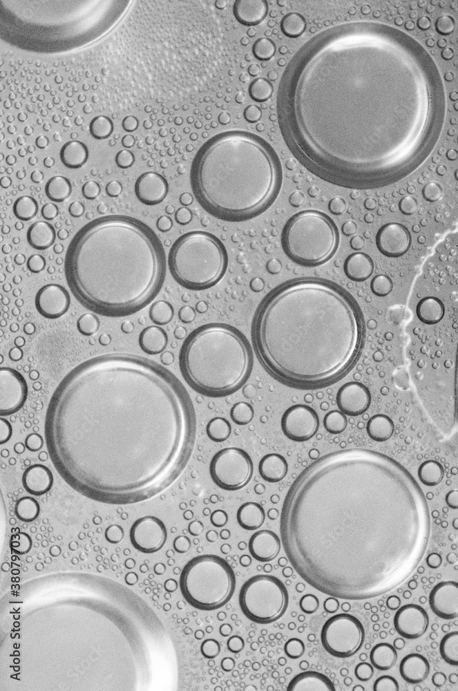closeup macro black and white of bubbles formed from intermixing water and oil closeup macro black and white of bubbles formed from intermixing water and oil