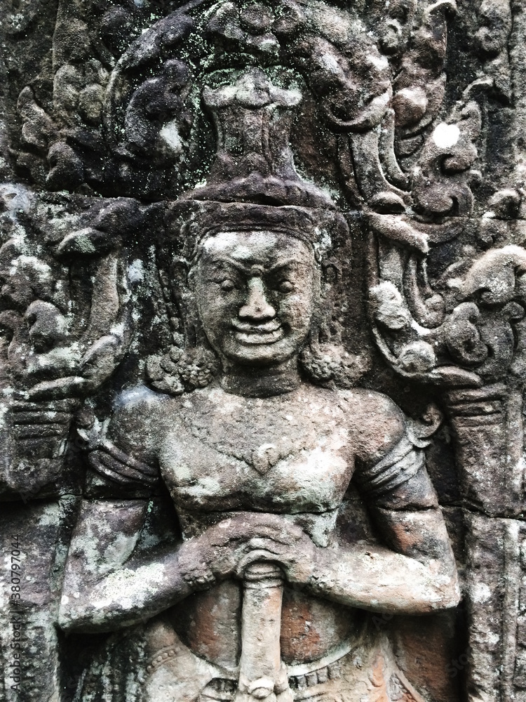 Stone figures carved in ancient temple wall Stone figures carved in ancient temple wall