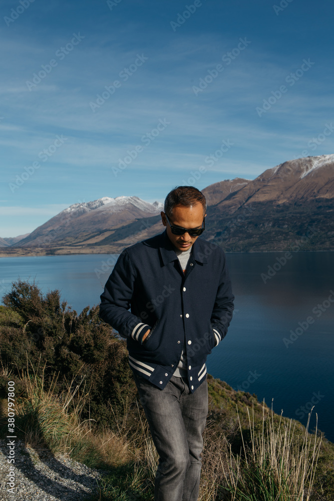 A young man enjoying the view of Lake Wakatipu A young man enjoying the view of Lake Wakatipu