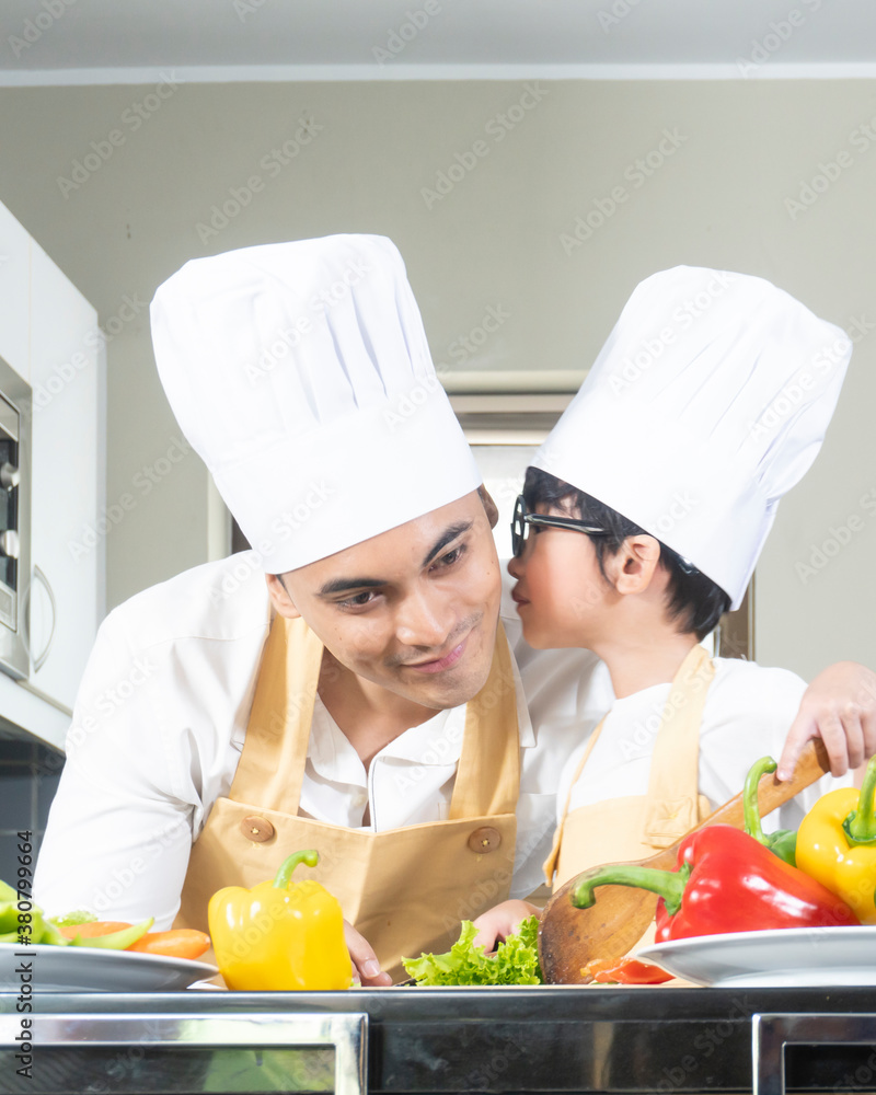 papa and son chef cooking in the kitchen during holiday papa and son chef cooking in the kitchen during holiday