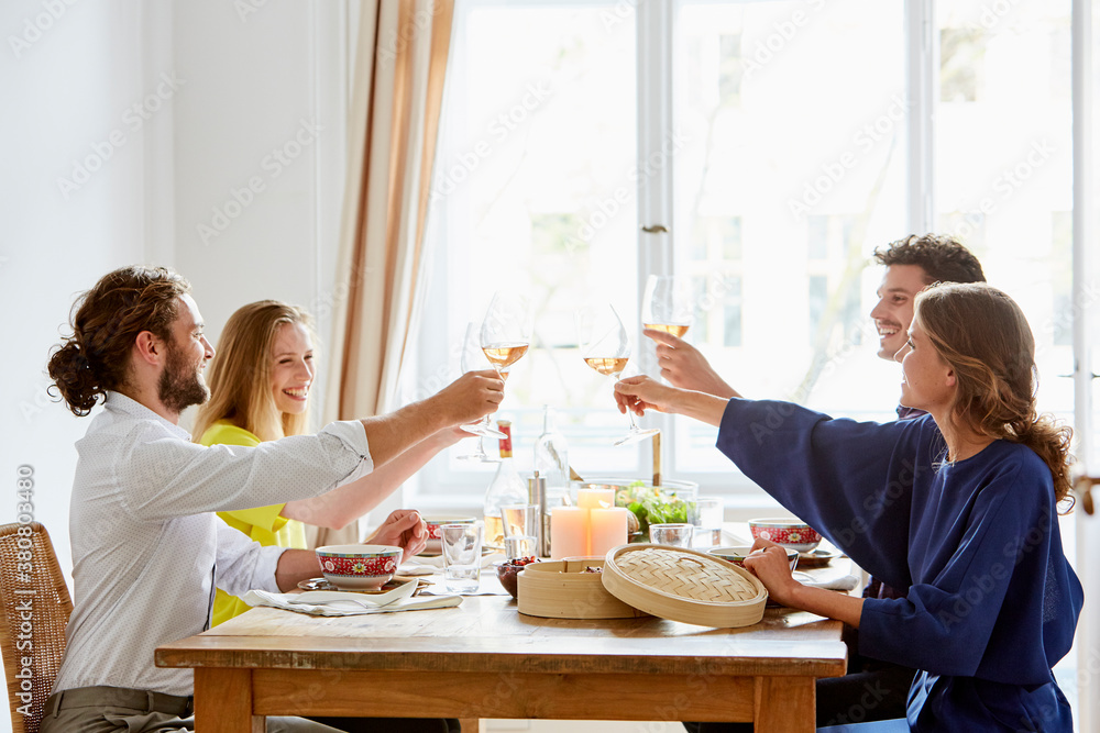 Happy Friends Toasting Wine Glasses At Dining Table Happy Friends Toasting Wine Glasses At Dining Table
