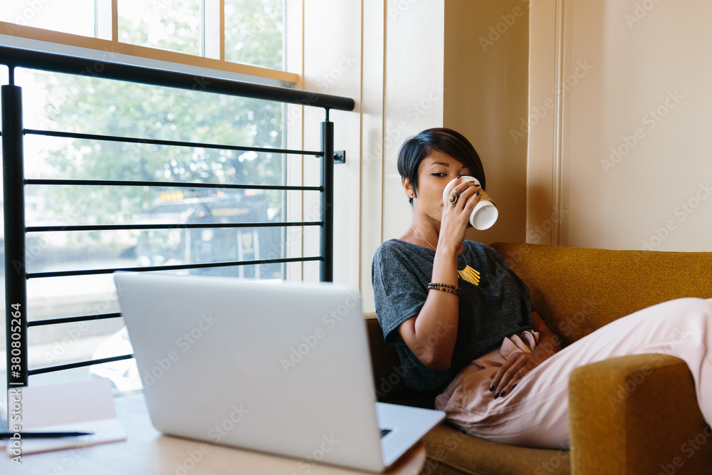 Young Woman Drinking a Coffee in a Shop Young Woman Drinking a Coffee in a Shop
