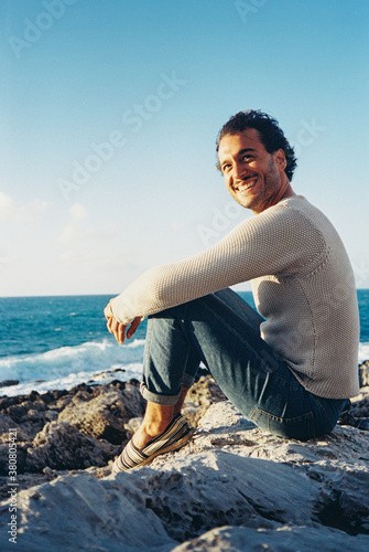 Smiling Italian Man Sitting By The Sea (Shot on Porta 400 Film) photo