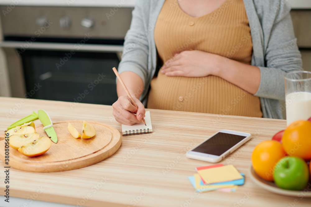 Pregnant woman preparing healthy food