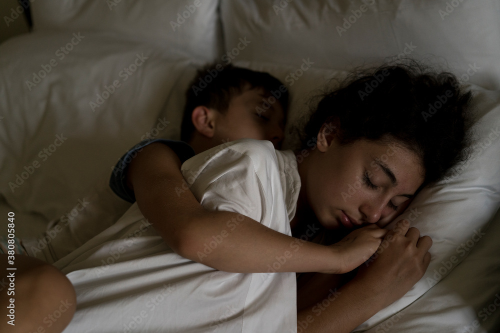Boy hugging his sister while sleeping Boy hugging his sister while sleeping