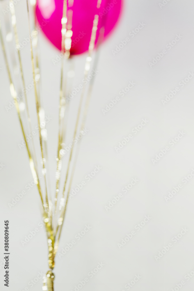 Blurry gold sequin strings hanging from balloons Blurry gold sequin strings hanging from balloons