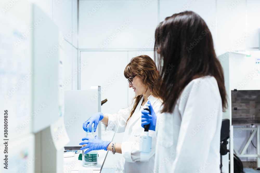 Doctors working together in scientific lab Doctors working together in scientific lab