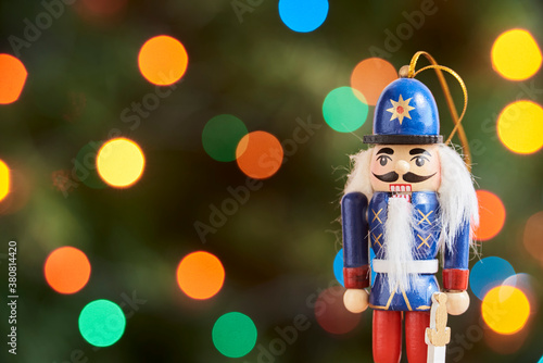 Traditional Christmas nutcracker with out of focus colored light background