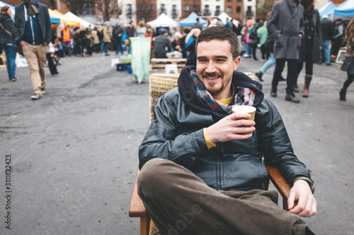 Man Sitting on an Armchair in a Flea Market photo