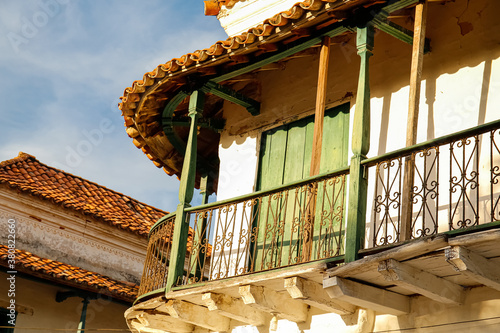 View to traditional wooden balcony wit green door in sunlight, Santa Cruz de Mompox, Colombia, World Heritage photo