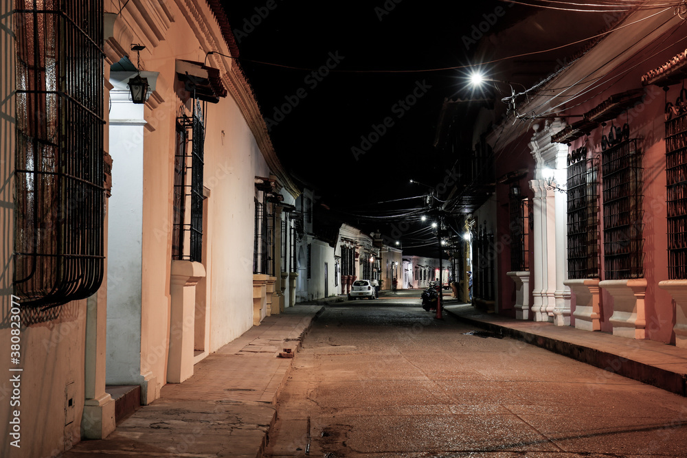 View to typical street with one story buildings at night in light of lanterns, Santa Cruz de Mompox, Colombia, World Heritage View to typical street with one story buildings at night in light of lanterns, Santa Cruz de Mompox, Colombia, World Heritage
