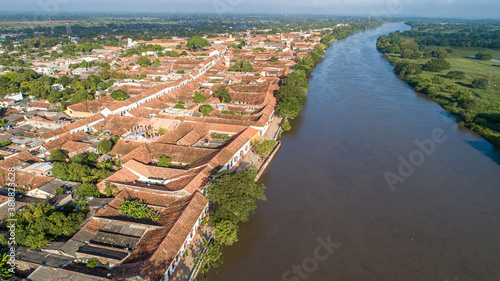 Aerial view of the historic town Santa Cruz de Mompox in sunlight with river and green sourrounding, World Heritage photo