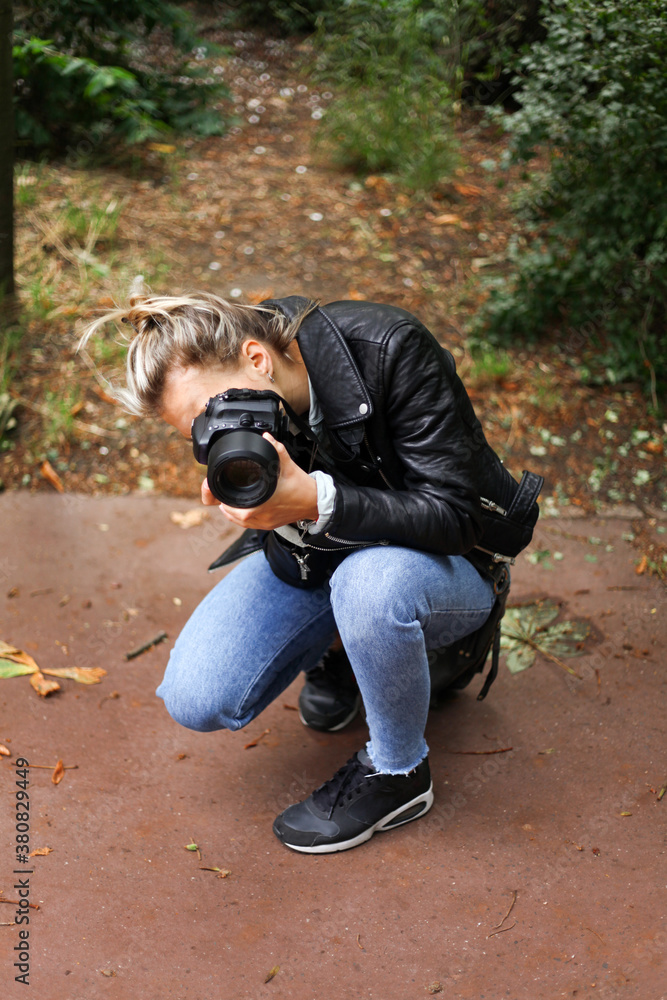 Young woman taking a photograph with photo camera Young woman taking a photograph with photo camera