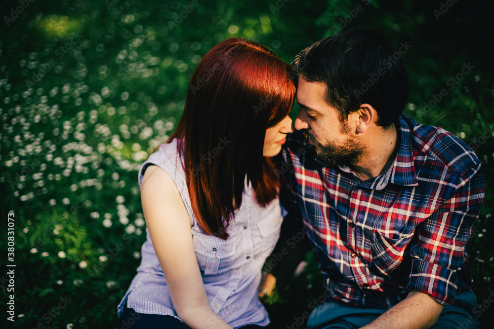 Young couple kissing in the park Young couple kissing in the park