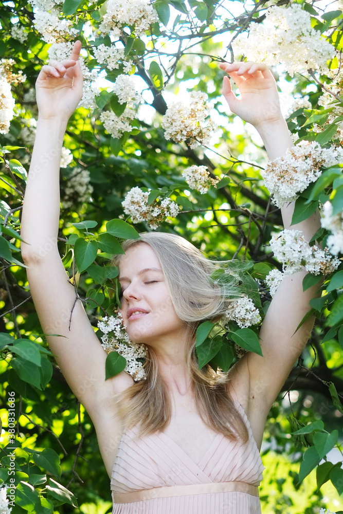 Young woman enjoys lilac blossom Young woman enjoys lilac blossom
