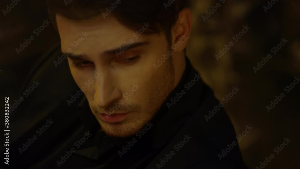 Handsome guy looking away in dark background. Stylish man considering something. Handsome guy looking away in dark background. Stylish man considering something.