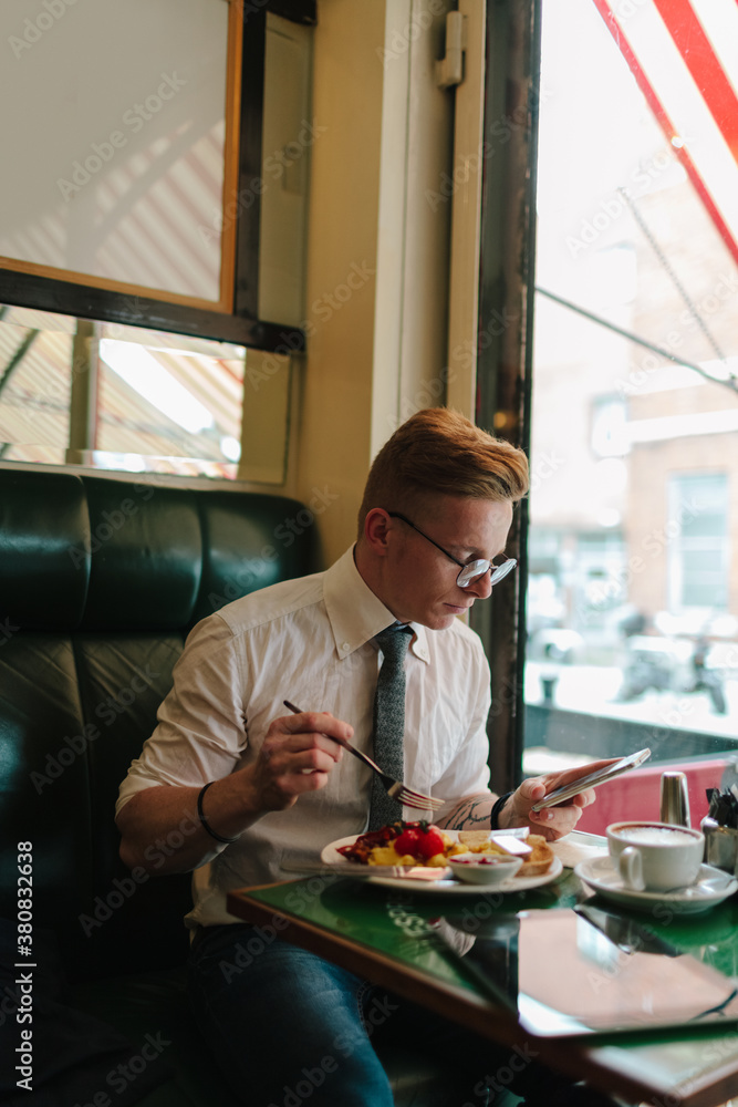 Young Entrepreneur Having English Breakfast in Coffee Shop Young Entrepreneur Having English Breakfast in Coffee Shop