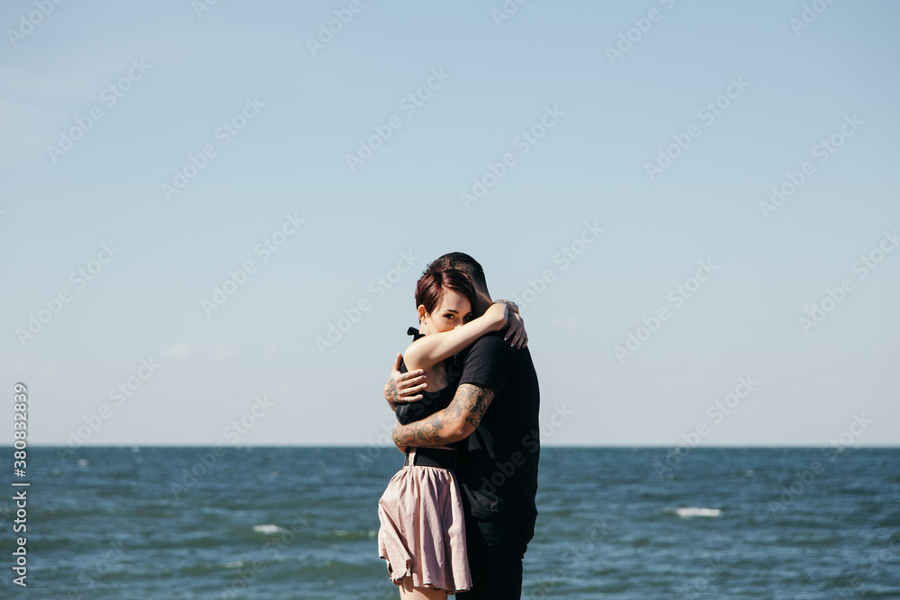 Happy caucasian couple embracing each other on the beach Happy caucasian couple embracing each other on the beach