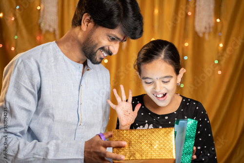 Excited little Siter got gift from her Bother during Raksha Bandhan, Bhai Dooj or Bhaubeej Indian religious festival ceremony. photo