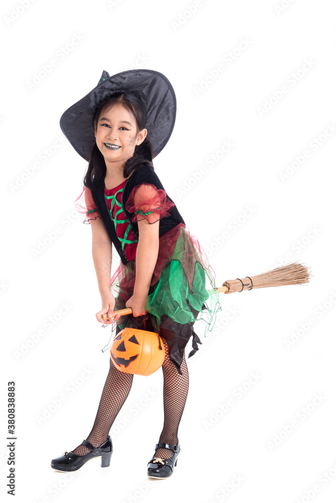 Full length of little asian girl in witch costume with make up riding on broom and smiles over white background. Child Halloween costume concept. Full length of little asian girl in witch costume with make up riding on broom and smiles over white background. Child Halloween costume concept.