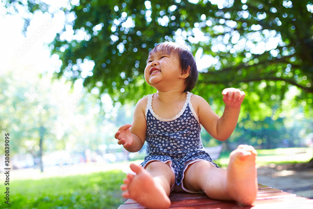 lovely little asian girl playing outdoor in the park lovely little asian girl playing outdoor in the park