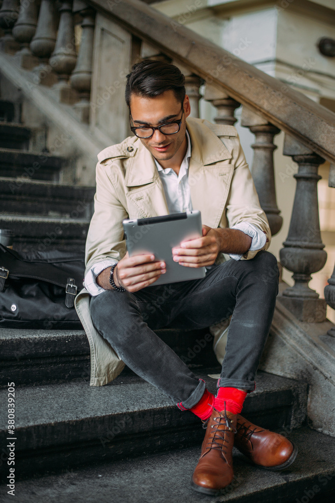 Young man working on tablet. Young man working on tablet.