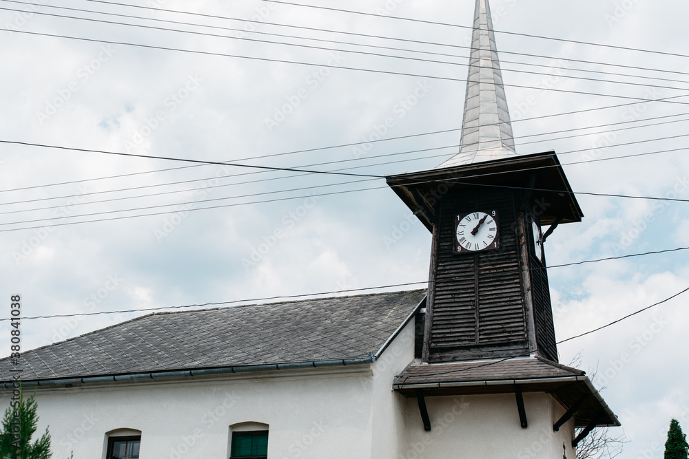 Old church with clock tower in a rural Hungarian village
