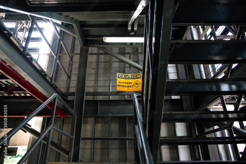 Caution Slippery When Wet warning sign in carpark steel stairways Stock ...