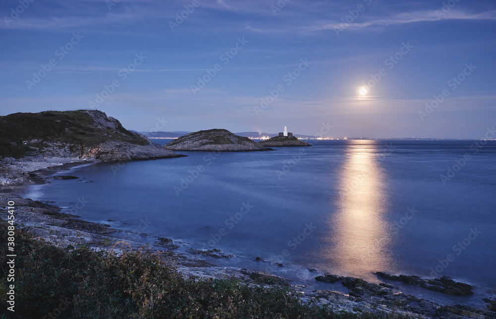 Full moon and lighthouse at Mumbles Head. Wales, UK. Full moon and lighthouse at Mumbles Head. Wales, UK.