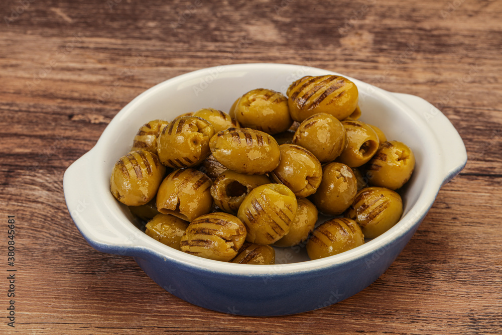Green grilled olives in the bowl Green grilled olives in the bowl