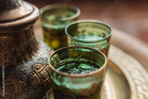 Green tea with mint served in artisanal glasses and teapot from Maghreb photo